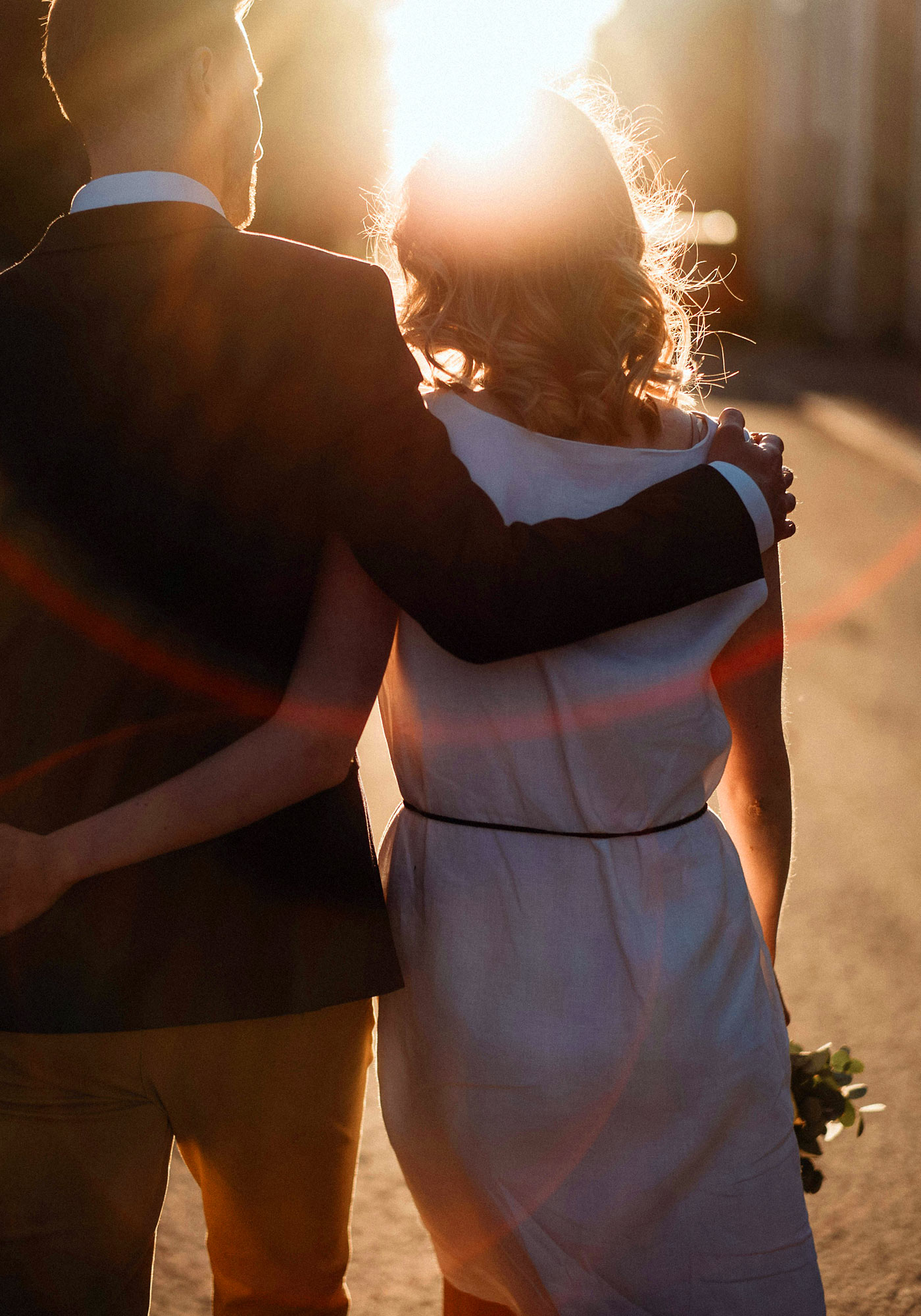 Newlyweds walking together in sunset light