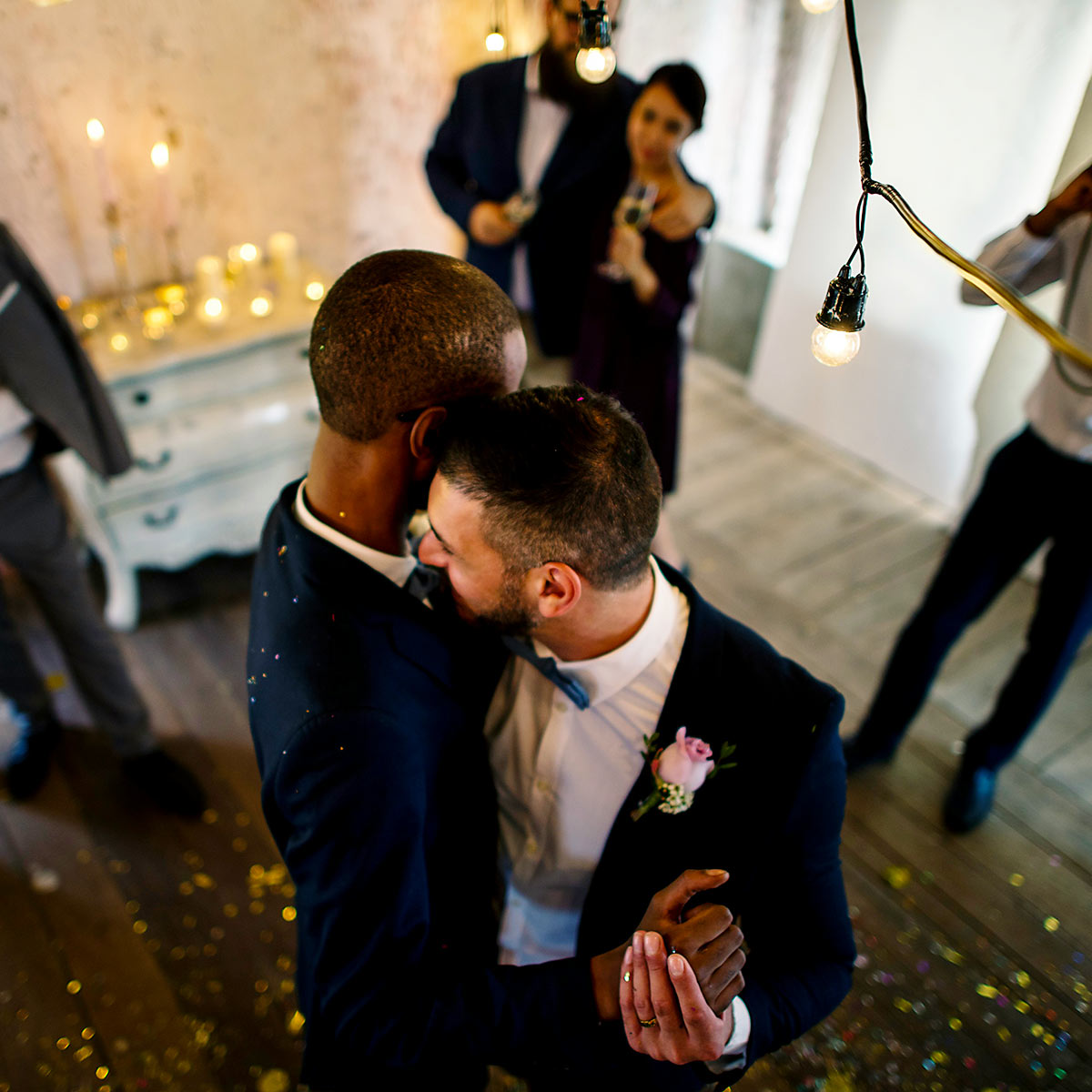 Two grooms dancing at their wedding reception